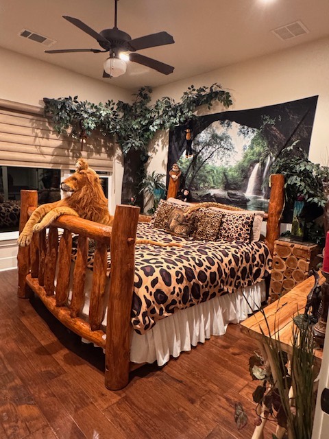 Log-frame bed with leopard-print bedding in the African Rainforest Room
