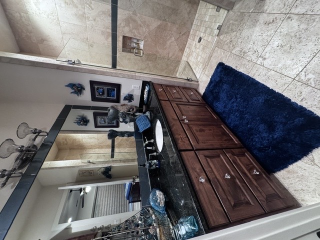 Private bathroom vanity and tiled walk-in shower