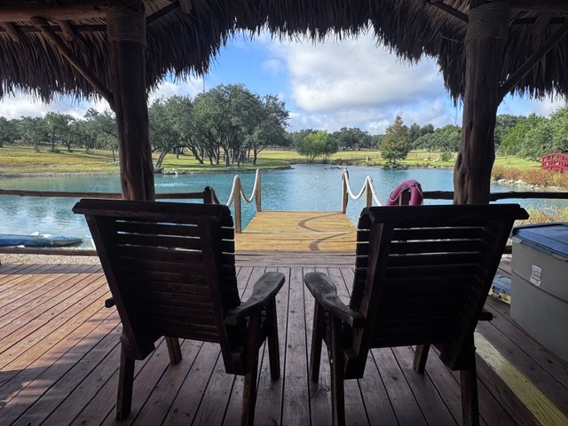 The wooden dock extending from the gazebo onto the ranch pond