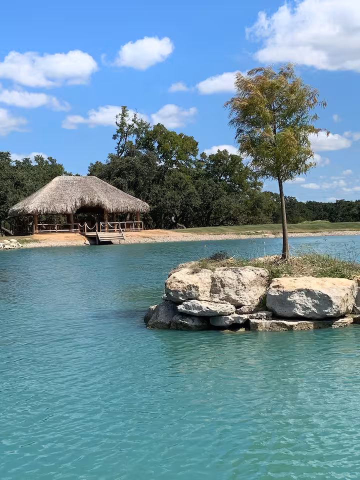 Small island in the ranch pond with the gazebo beyond