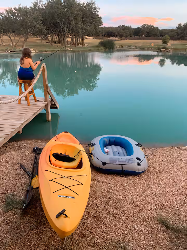 Kayak and paddle boat beside the dock at dusk