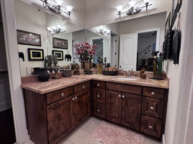 Private bathroom vanity with wooden cabinets and mirrors