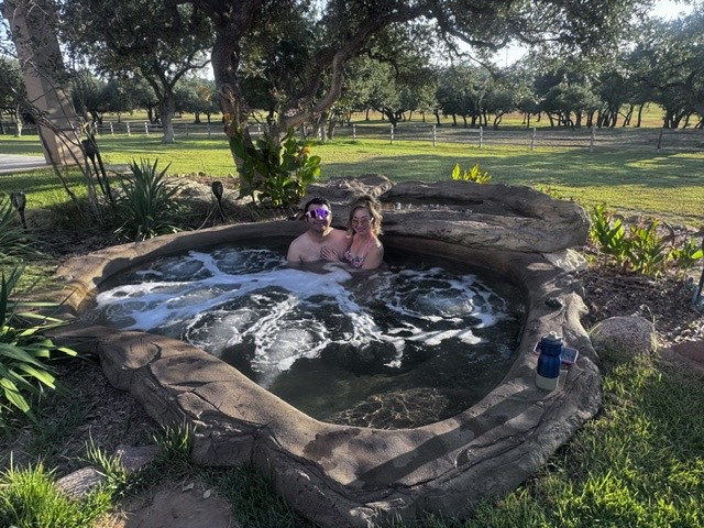 Guests relaxing in the ranch hot tub